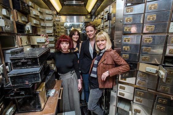 The cast of Blue Moon Over Poplar among the Hatton Garden safety deposit boxes